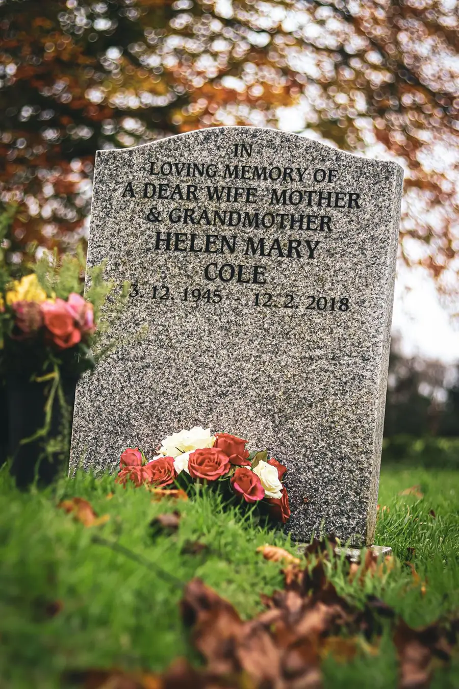 Engraved gray granite headstone with roses